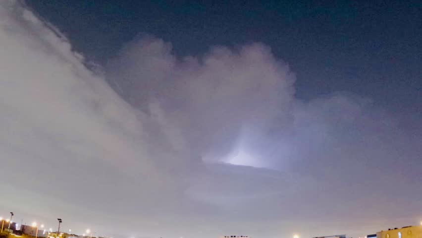 Dramatic lightning strikes illuminating the dark night sky during a storm."
