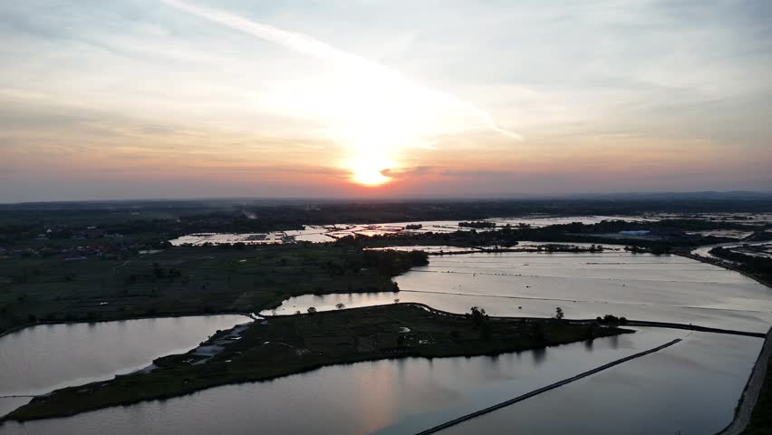 Aerial View of Golden Sunset Reflected in a Rural Aquaculture Pond
