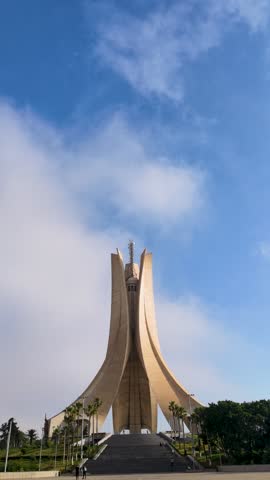 A low-angle, architectural view of the iconic Maqam Echahid (Martyr