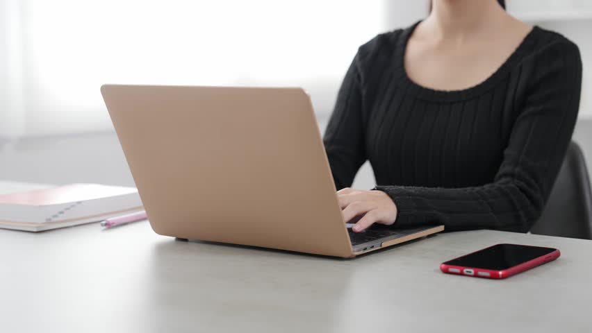A woman working on her laptop.