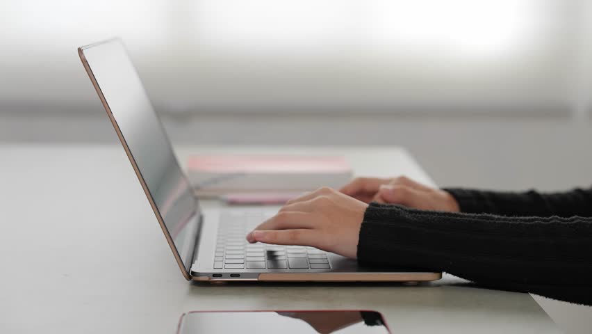 A woman working on her laptop.
