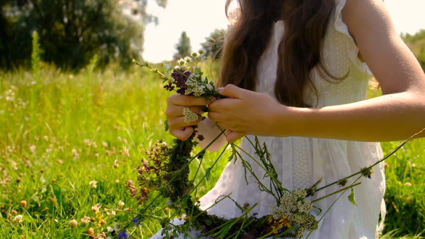 Children girl and flowers on Ivan Kupala Day. Selective focus. Nature.