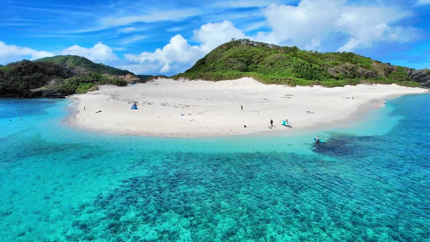 Aerial view of Gahijima Island white sand beach in Okinawa, Japan
Aerial drone footage of Gahijima Island near Zamami in Okinawa, Japan. Crystal-clear turquoise waters, white sandy beaches, and tropical island scenery under a sunny sky.