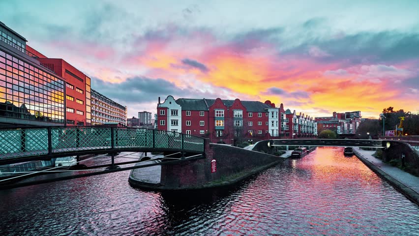 Timelapse aerial view of Birmingham Canal Quarter at sunset, showcasing urban waterways, modern architecture, and the vibrant cityscape of Birmingham, England. October 8, 2025, highlights the dynamic atmosphere of one of the UK’s major cities.