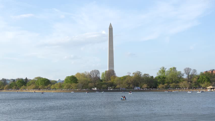 Washington DC USA Washington Monument Tidal Basin Green Trees People in Boats in Lake. Beautiful Day Blue Sky Spring. United States of America