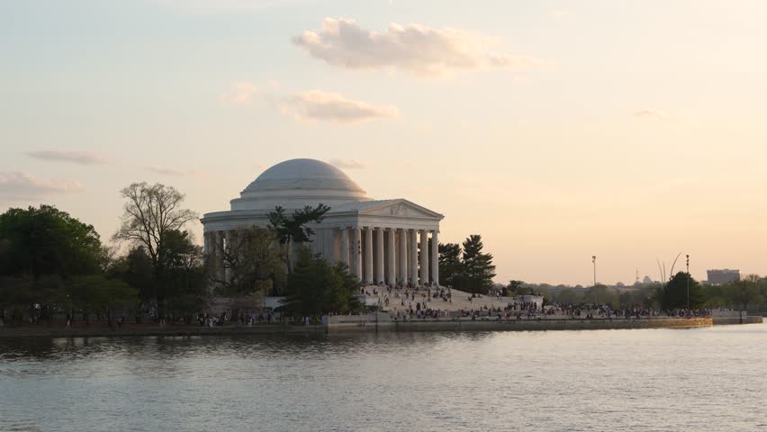 Jefferson Memorial in Washington DC at Sunset View Across Tidal Basin Water. People Gather on Steps. Beautiful America National Capital Historic