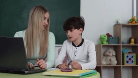 Teen mentor teaching child coding on laptop, STEM education and digital skills concept - Powered by Shutterstock - Get 15% off with code: PIKWIZARD15
