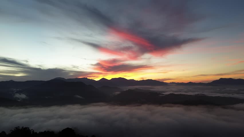 Aerial View of Sunrise Over Foggy Mountains