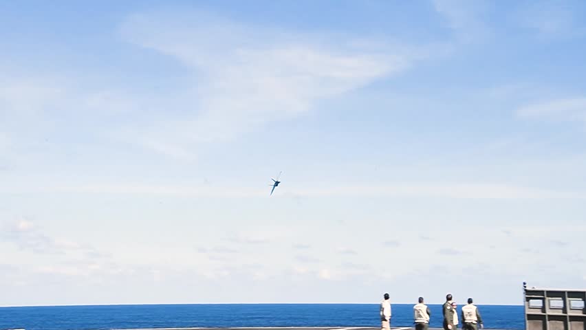High-Speed Military Jet Executing Precision Maneuvers Through Clear Blue Skies During Training Operations Today.