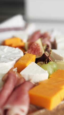Cheese Board With Fruits And Ham On A Table, Appetizing Platter For A Wine Party, Vertical Video