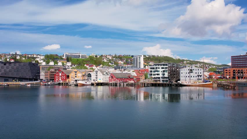 Troms Harbour features vibrant buildings and calm waters, showcasing the stunning landscape of the northern Norwegian city. This picturesque area is perfect for walking and sightseeing.