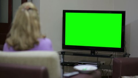 Couple sitting in front of blank green TV screen
