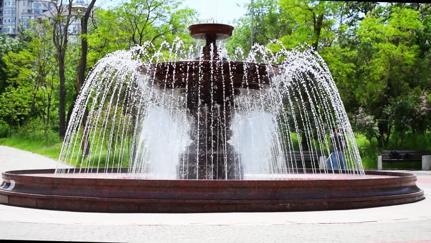 A classic functioning fountain in a city park.