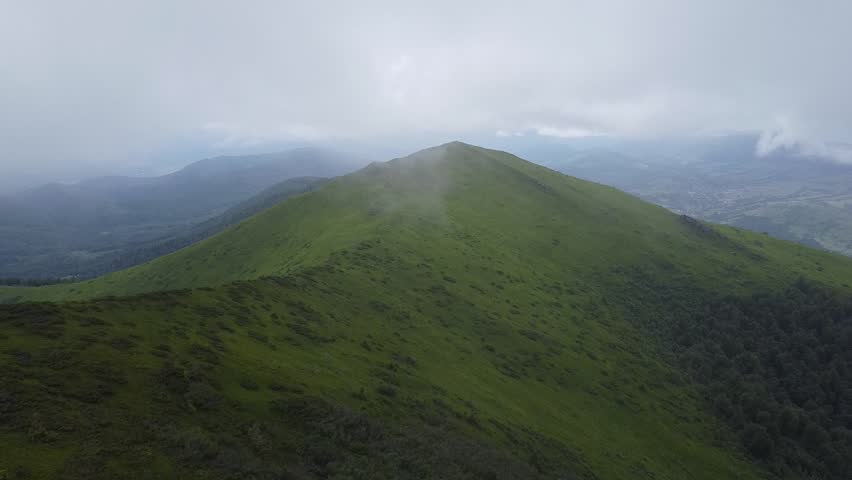 Misty green mountain hills aerial landscape in clouds