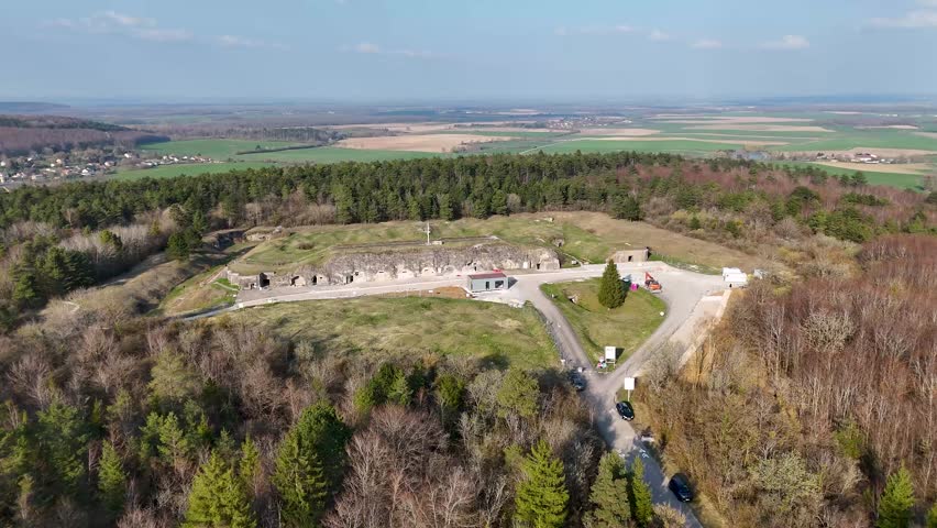 Drone image of cratered grassy terrain, paths, and fort remains at Fort de Vaux near Verdun in Grand Est, France.