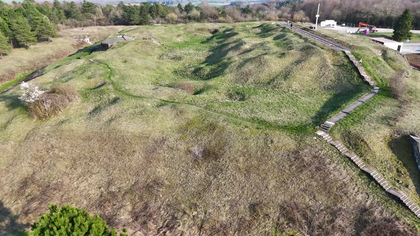 Drone view of Fort de Vaux earthworks, concrete entrances, forest, and farmland near Verdun in Meuse, Grand Est, France.