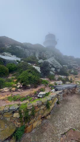 Old Cape Point lighthouse near Cape of Good Hope in the morning mist. South Africa.