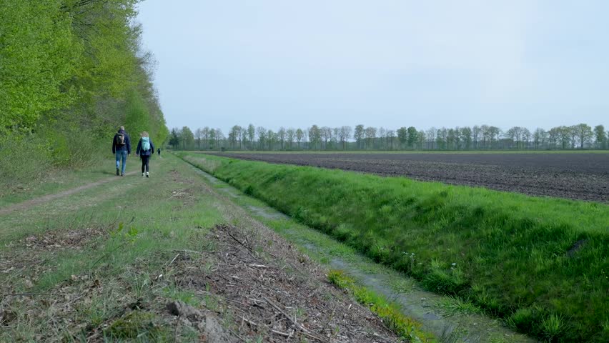 hiking a path between forest and field