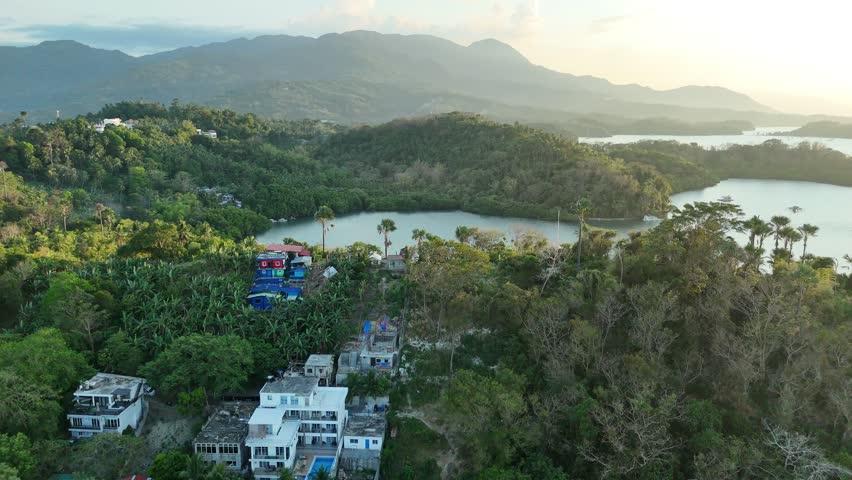 Aerial view of forested Puerto Galera bays with boats and mountain coastline