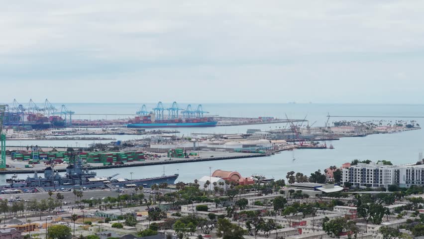Battleship USS Iowa museum at Port of Los Angeles with container ships, cargo cranes, shipping terminals, San Pedro neighborhood overlooking Pacific Ocean coast