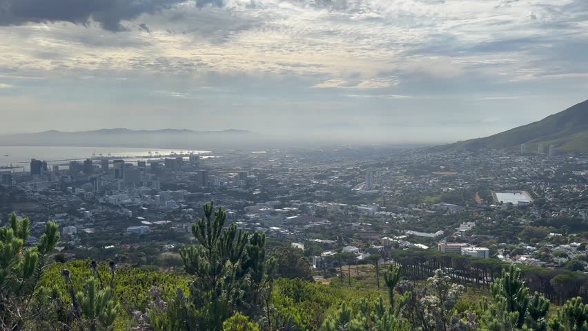 Pan right view of suburb of Cape Town at the foot of Table Mountain. South Africa.