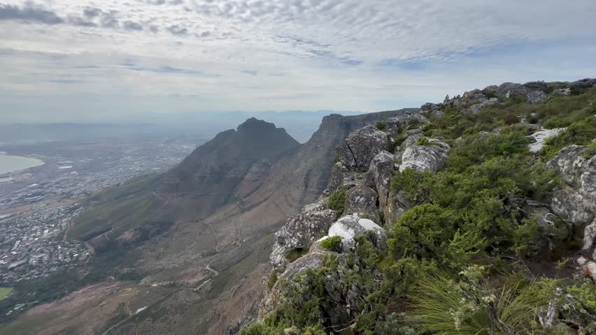 Sweeping view from a rocky cliffside overlooking Table Mountain in Cape Town, South Africa.