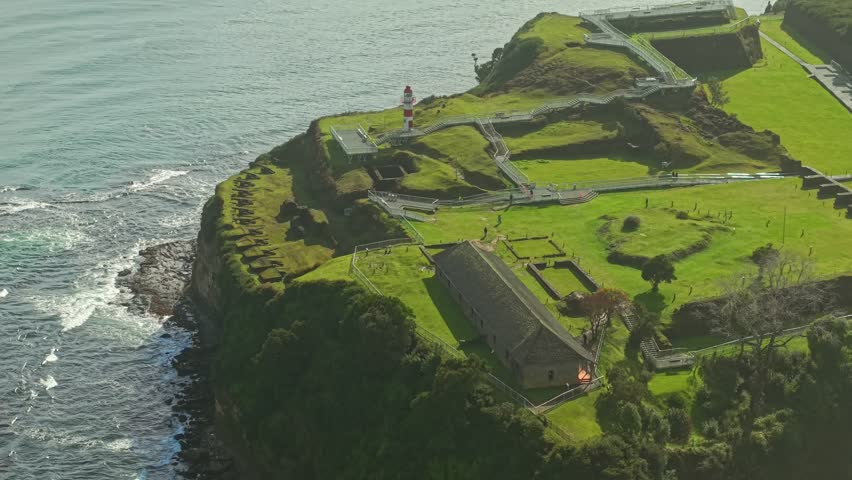 Flyover establishing of Fort Niebla, with a line of cannons and the Castellano house, with a modern walkway for visitors to explore, Valdivia, Chile