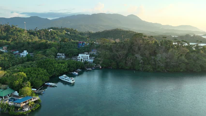 Aerial view of waterfront homes and boats in Puerto Galera bay