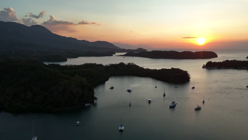 Drone view of Puerto Galera islands and anchored boats during sunset