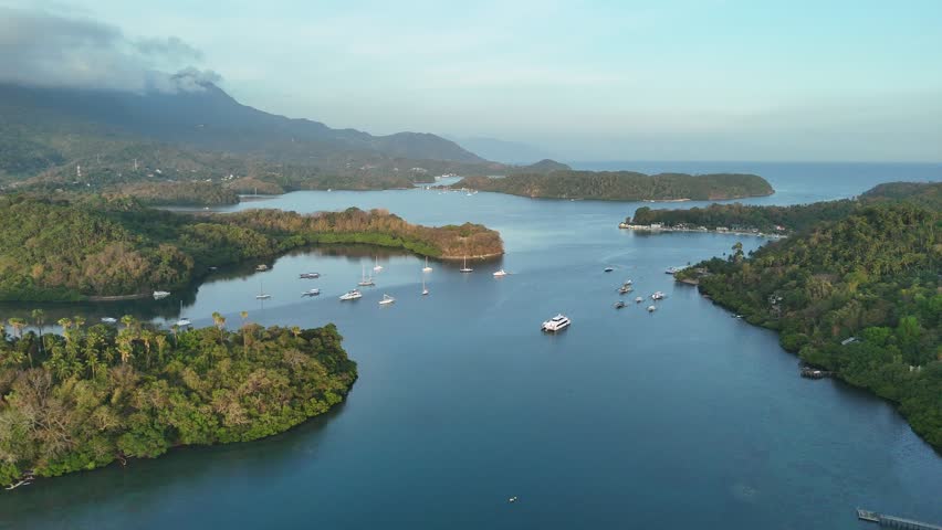 Wide aerial drone view of Puerto Galera bay with islands and anchored yachts