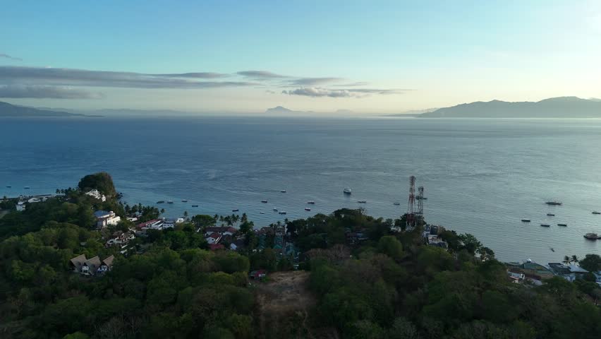 Drone aerial of Sabang Puerto Galera coastline during peaceful tropical sunset