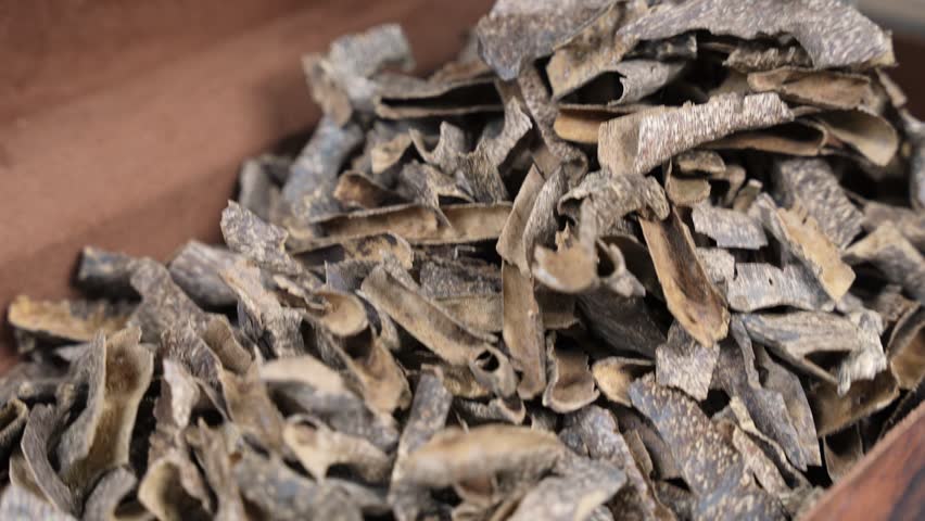 A detailed close-up shot of a pile of raw, high-quality agarwood chips used for traditional incense and exotic perfumery.