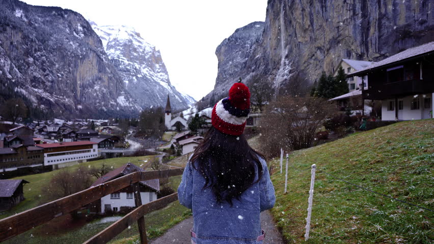 Tourists visit the village of Lauterbrunnen while it is snowing, Switzerland.