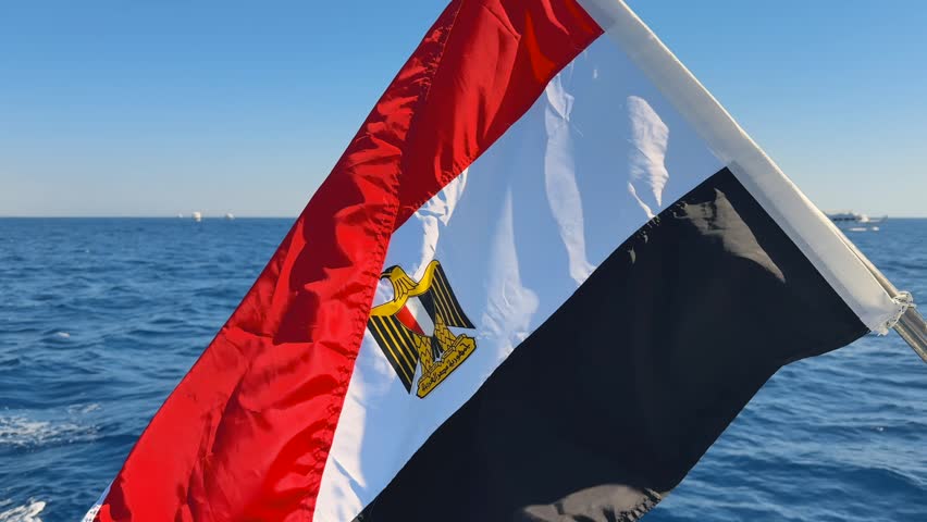 Close up of Egypt national flag on boat upper deck waving in the strong wind