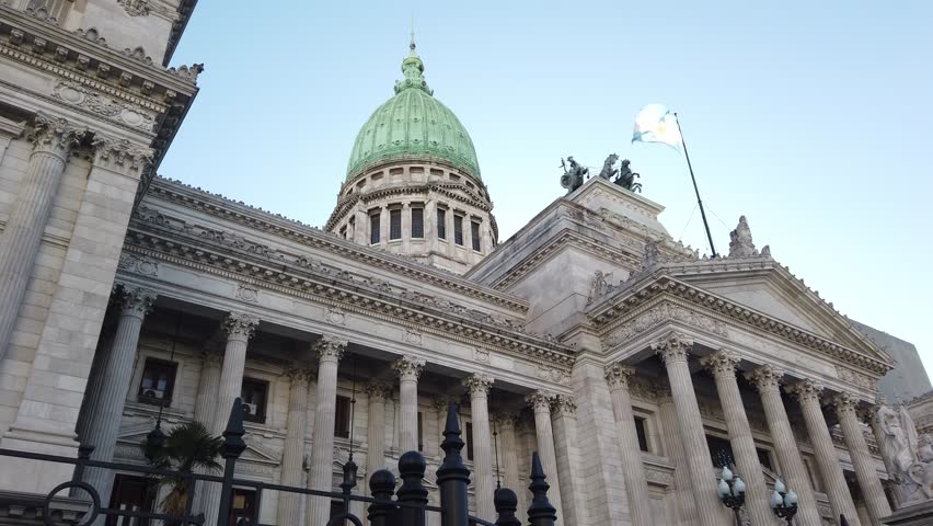 Low Angle Detail of National Congress Palace Argentina Buenos Aires city Dome Statues and Flags Waving Against Sunset Sky