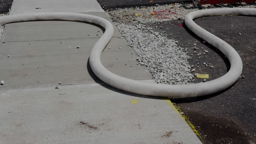 Insulation material being pumped through a hose at a residential construction site for home Insulation installation. Close up