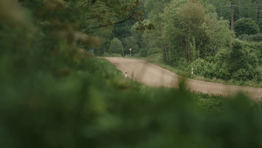 Tracked Infantry Fighting Vehicle Advancing Near Village During Training Exercise