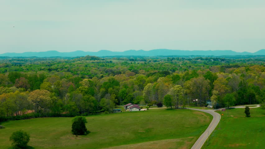 Drone flies over a tree lined street in Louisville, Blount County, Tennessee, USA