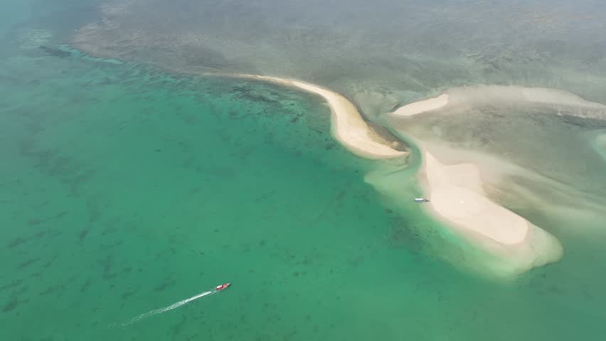 An aerial view of the Thai sea and its beautiful beaches, showcasing important tourist destinations in Thailand.