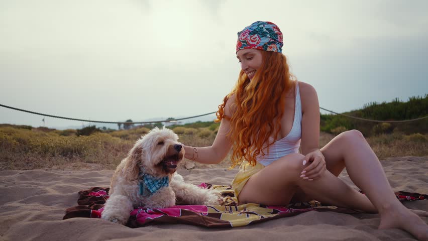 Redhead woman hugging doodle dog showing affection