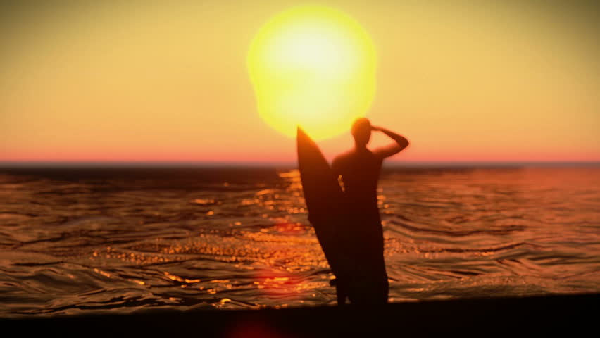 Silhouette of a surfer with his surfboard on the sunset
