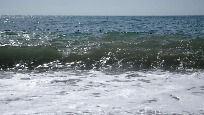 The breathtaking sight of the mighty ocean waves crashing against the shore, creating a cascade of white foam. Waves crashing against the rocks, creating a spectacle of foam and spray.