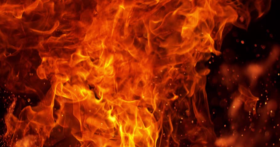 Ultra slow motion intense fire texture filling the frame at 1000 FPS. Detailed flames, glowing combustion and flying sparks create a powerful cinematic fire background effect.