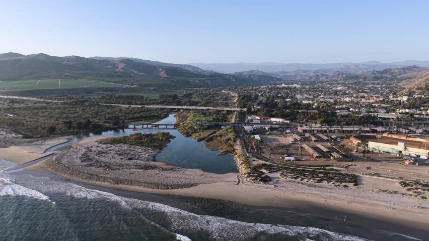 Amtrak Pacific Surfliner Train Crossing Ventura River Bridge heading North up the California Coast to Santa Barbara and San Francisco. Scenic Passenger Train Ride in West Coast USA.