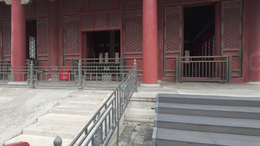 Ornate Forbidden City palace facade with red columns and painted eaves in Beijing courtyard