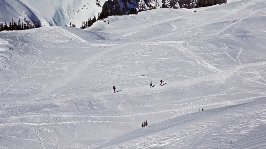 Footage of individuals backcountry skiing or snowshoeing along the popular Skyline Trail towards Panorama Point in the winter or spring. The trail is located in the Paradise area of Mount Rainier Nati