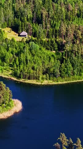 Wooden cabins nestled in lush forests surrounding serene lakes. Ideal for real estate promotions or nature documentaries.