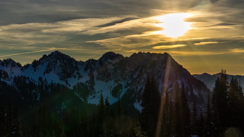 stock footage capturing the vibrant sunset over the majestic, snow-capped Tatoosh Range mountain peaks, as seen from the popular Skyline Trail near the Paradise area in Mount Rainier National Park, Wa
