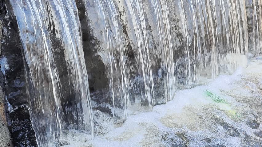 Close up of Clean River Water Flowing Down Creating Small Waterfall in 4K