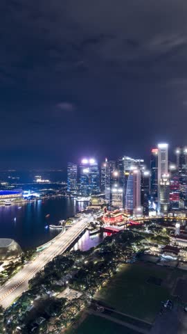 Time lapse of Marina Bay and the Singapore skyline at night. Vertical Video.